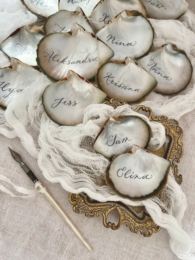 Oyster shell wedding place names handwritten with dip pen and ink