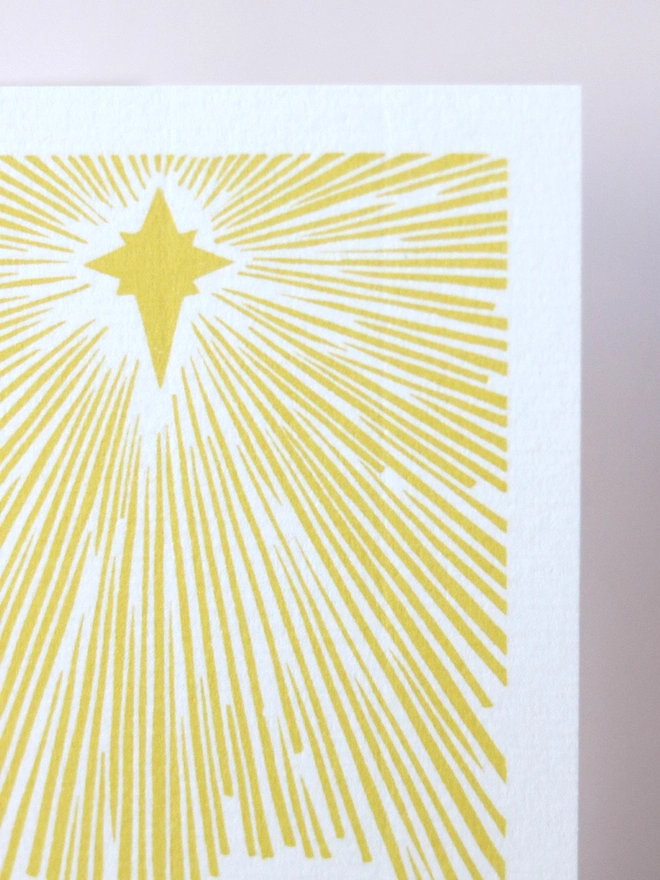 A Christmas card based on an original linocut design featuring Bethlehem and a star
