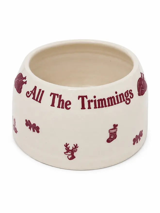 Handmade ceramic Christmas Cocker Spaniel Ear Free Bowl reading All The Trimmings, with burgundy festive motifs on a white background.