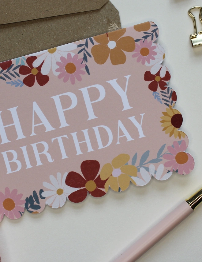 floral happy birthday card. scallop edged birthday card with illustrated flowers.