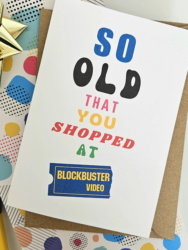 A photograph of the front of a humorous A6 greeting card illustrated using brightly coloured text and the retro shop logo. The text says so old you shopped at Blockbuster