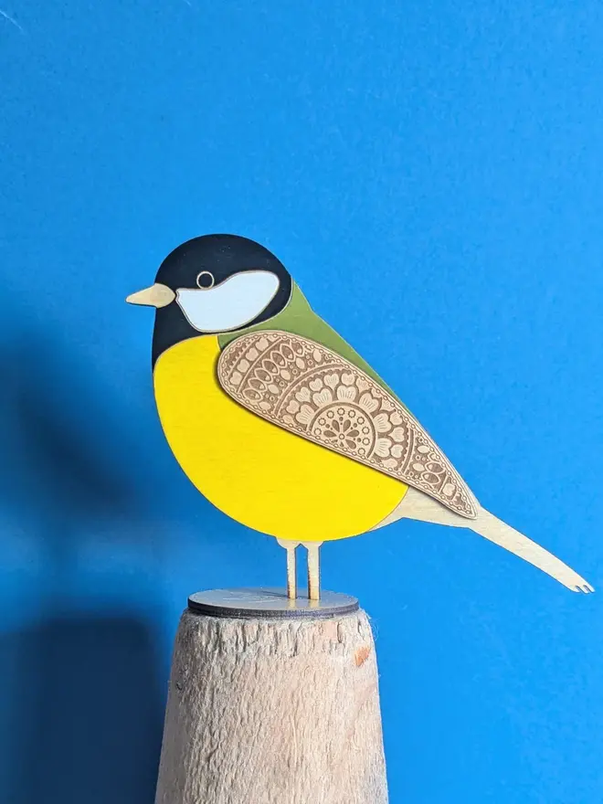 Standing Wooden Great Tit, yellow wooden bird decoration standing on a platform. 