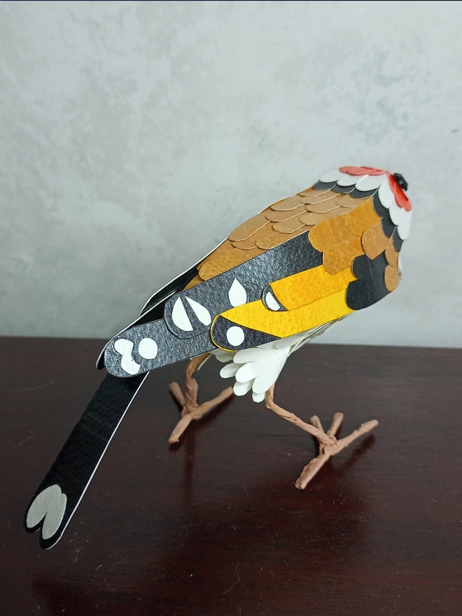 back view of a handmade goldfinch sculpture