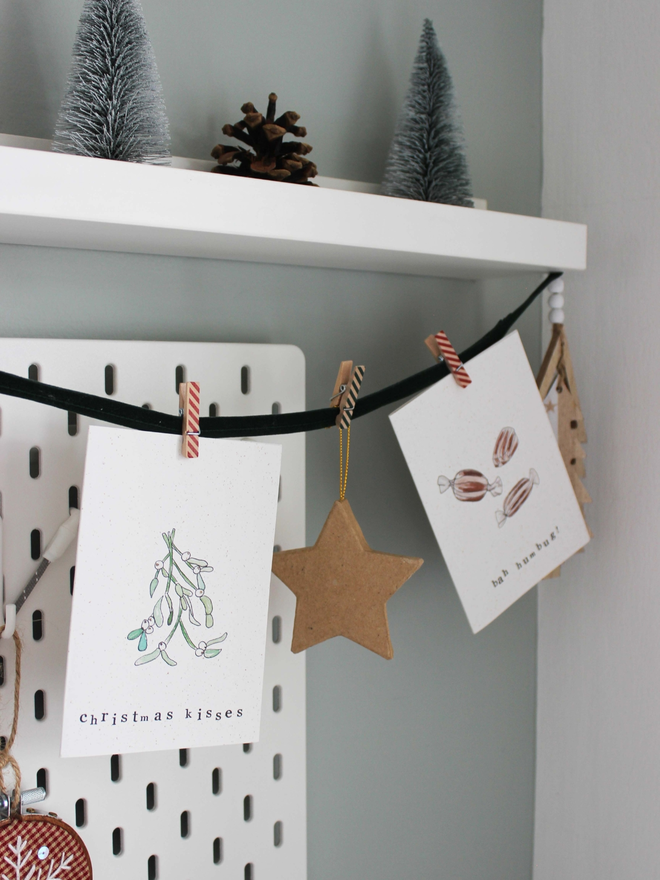 Christmas cards being displayed on ribbon