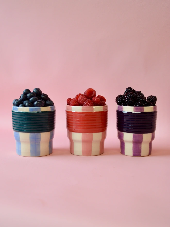 Striped ceramic tumblers with fresh berries