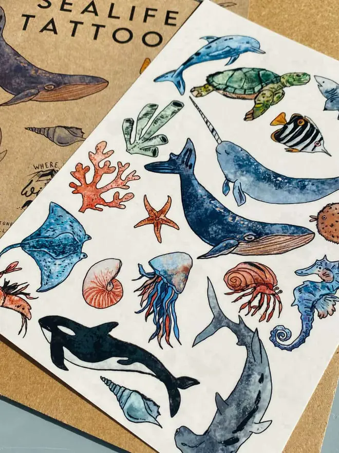 Animal Temporary Tattoos, a "SEALIFE TATTOO" booklet sits next to a sheet of colourful ocean animal temporary tattoos.