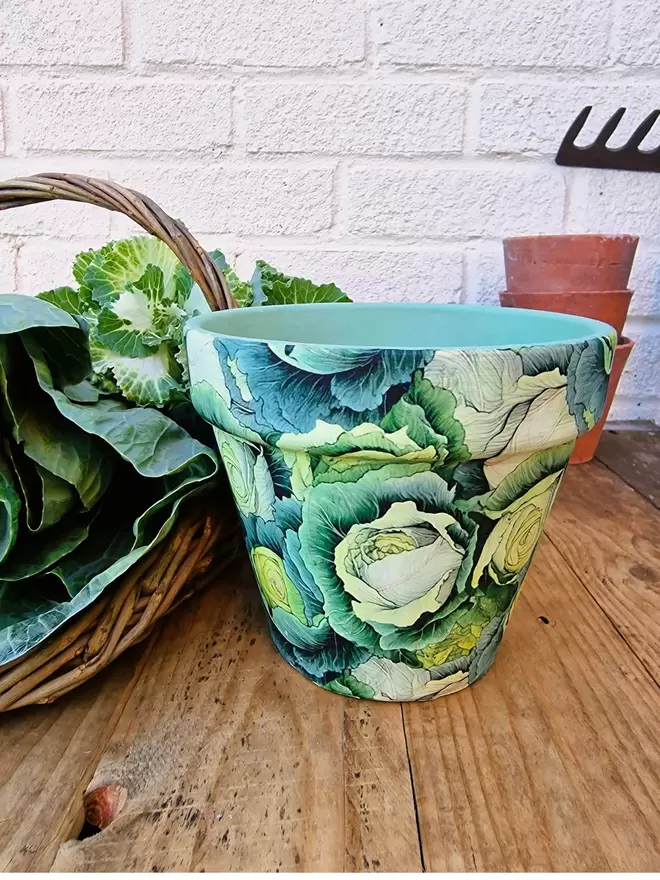 Cabbage design Plant pot Front view on a wooden chest