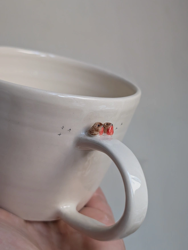 robin couple mug with a tiny pair of robin red breast birds on the cup handle and small bird prints on the white cup