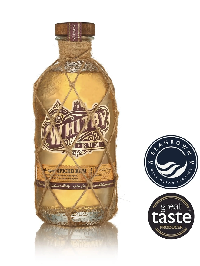 Whitby Rum, a bottle of rum sitting on a plain white surface. 