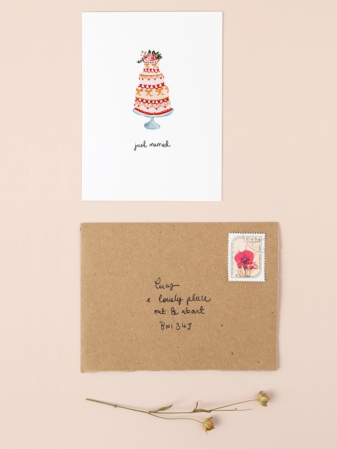 A charming illustration of a tiered wedding cake adorned with delicate floral accents and a "Just Married" hand written message. The design captures the joy and elegance of a wedding celebration, making it a perfect choice for sending heartfelt congratulations to newlyweds.