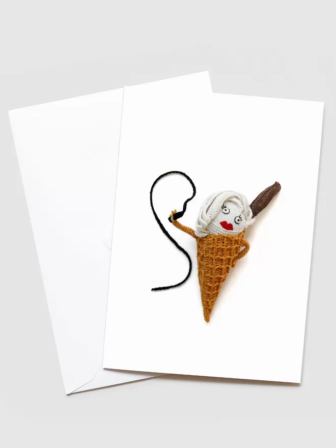 Kate Jenkins Mrs Whippy Card seen with an envelope. On the front is Kate's crotched Mrs Whippy with red lips, holding a whip.