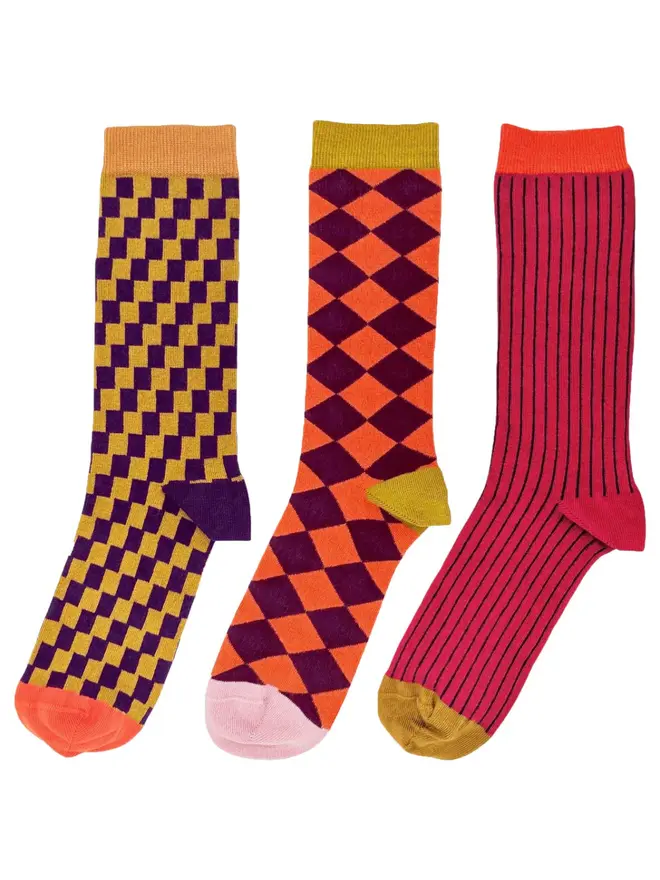Men's Organic Cotton Ankle Socks Packs (Sets Of 3), a set of colourful patterned socks sitting on a plain white surface. 