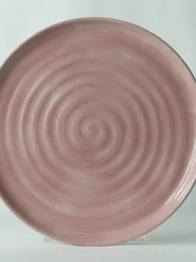 blush pink ceramic plate with textured swirl design