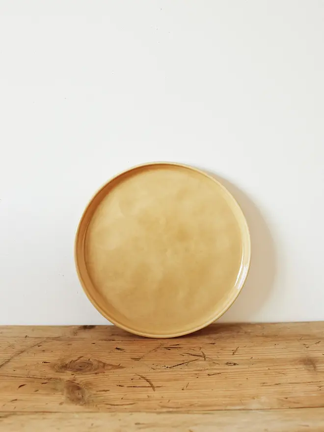 stoneware place setting dining set. a small yellow stoneware plate.