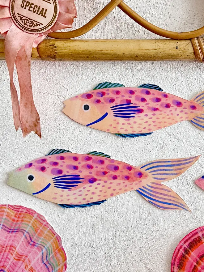 wooden fish wall decoration. wooden fish wall decorations hung on plain white wall.