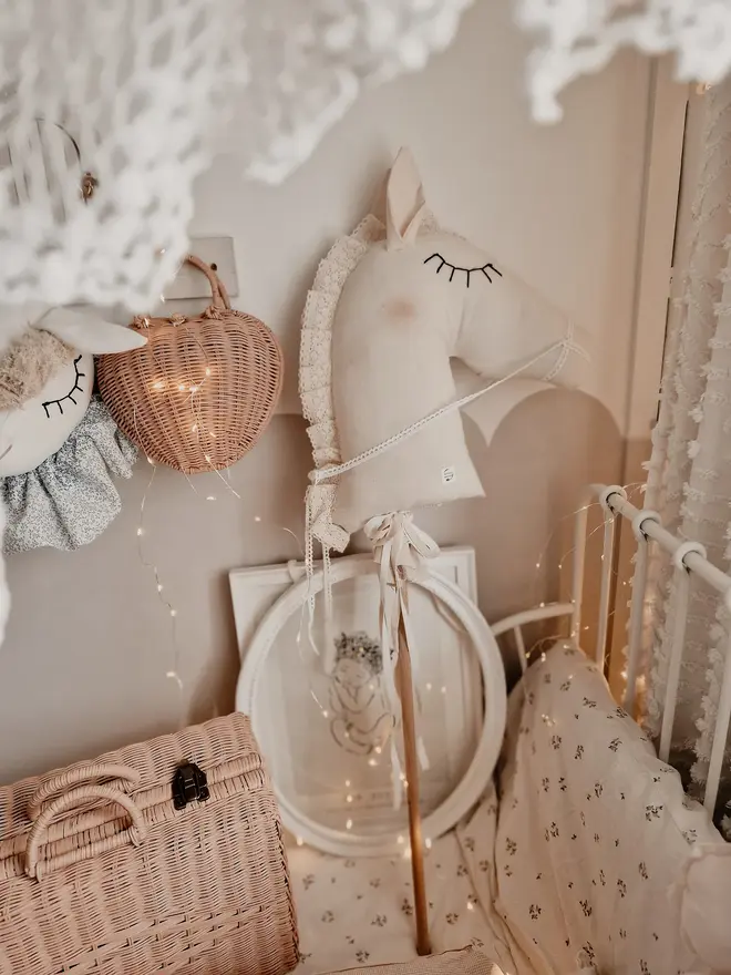 Handmade Cotton Hobby Horse Nursery Decoration, a cotton hobby horse sitting in a child's bedroom surrounded by other bedroom accessories. 