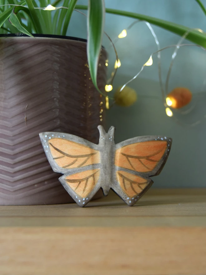 monarch butterfly wooden toy on shelf