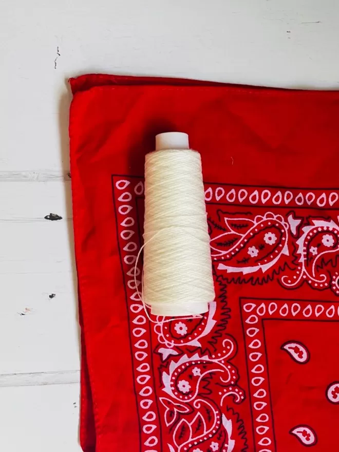 Red bandana with white thread,