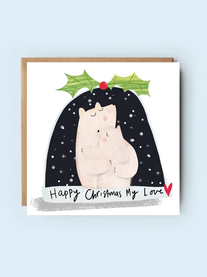'my love' snow globe christmas card. card photographed on plain blue background.