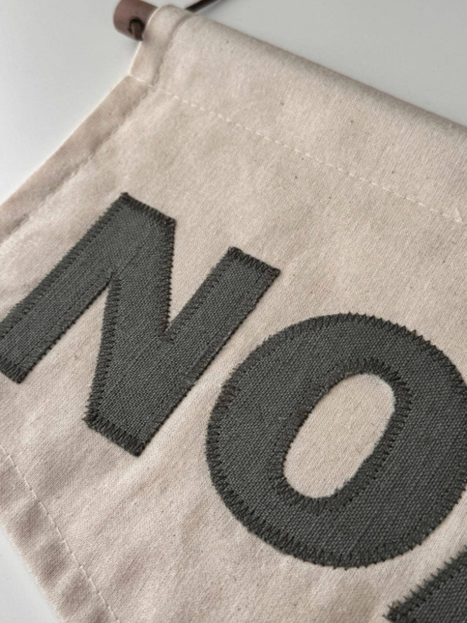 Linen Personalised Banner. A banner in small with ‘NOAH’ laying down.