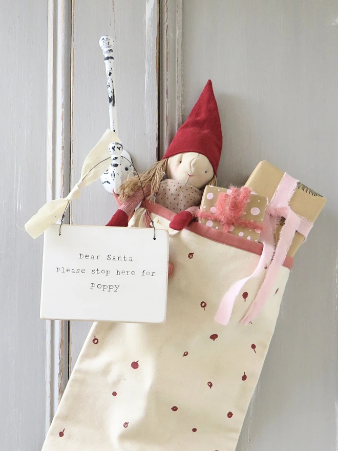 Chalky white painted wooden hanging sign with hand painted personalised Dear Santa message