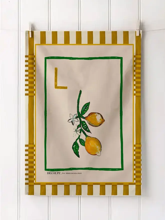 a-z alphabet tea towel. a tea towel with a lemon print and the letter 'l' in the corner.