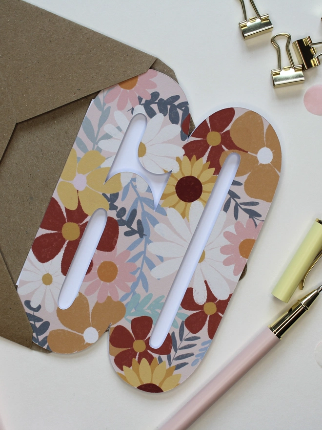 floral 60th birthday card. card shaped like 60 adorned with illustrated flowers.