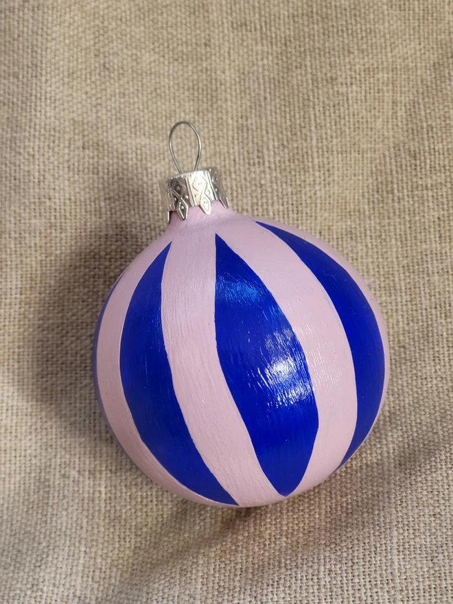 Cobalt blue bauble with pale pink stripes