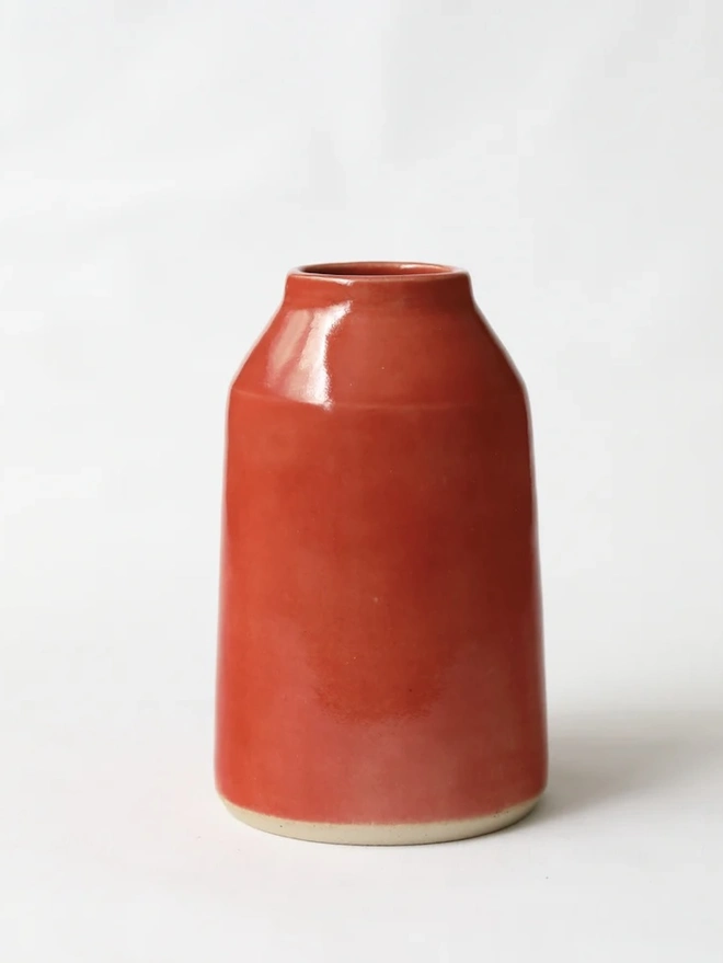 Classic Bud Vase, a colourful ceramic vase sitting on a plain surface against a white backdrop. 