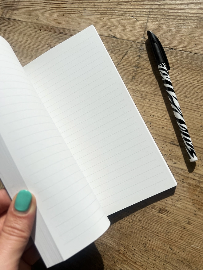 Inside of the notebook showing the lined white paper.