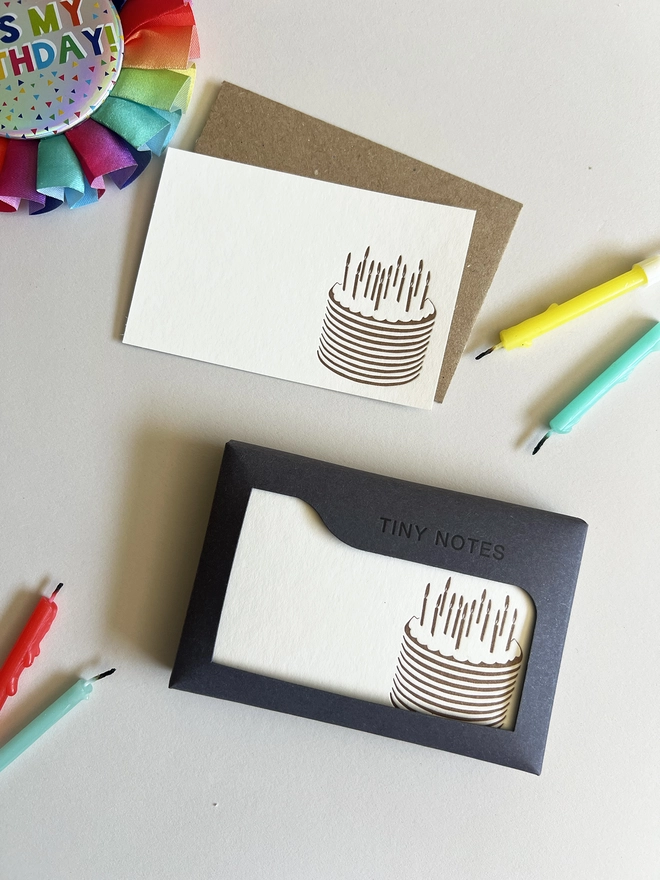 Tiny notes box with a card and envelope next to it.