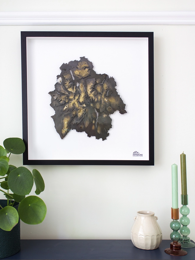 The Lake District National Park Map hanging on the wall in a black frame
