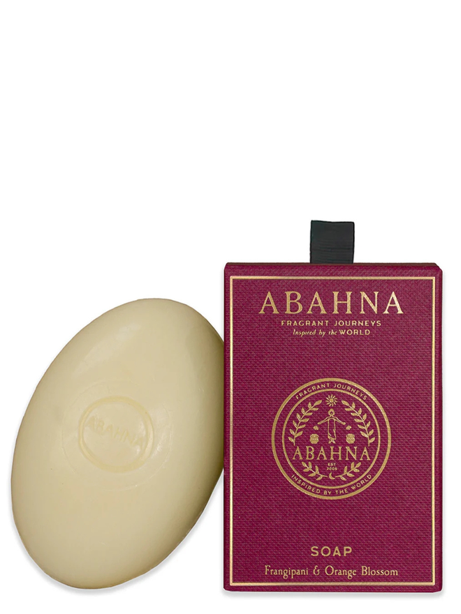 frangipani and orang blossom soap bar. a bar of natural soap leaning on a pink gift box.