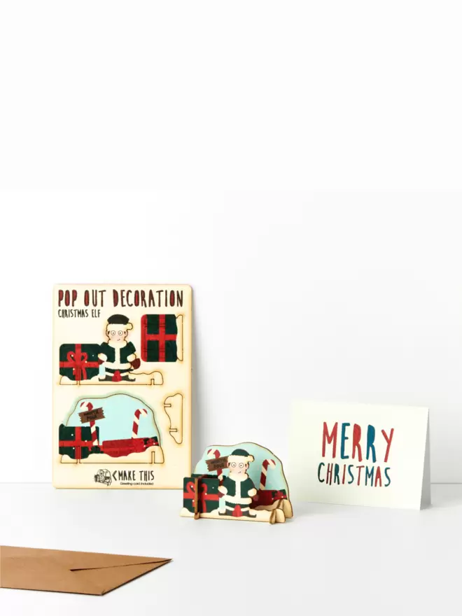 Elf Christmas decoration and Merry Christmas card on a white background