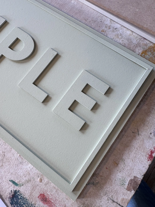 close up of a colour drenched hand painted sign by modo