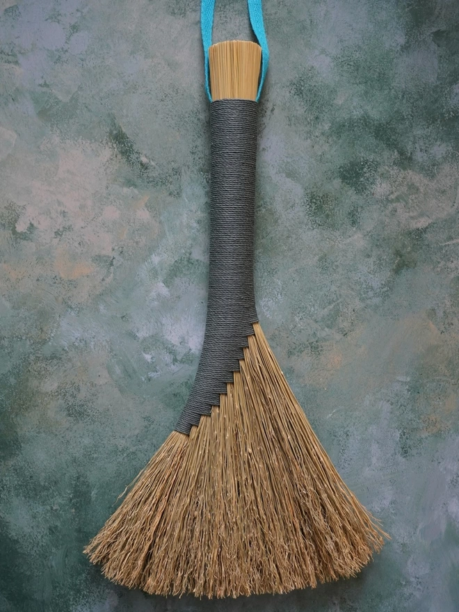 Broomcorn handbroom with teal hemp cord binding