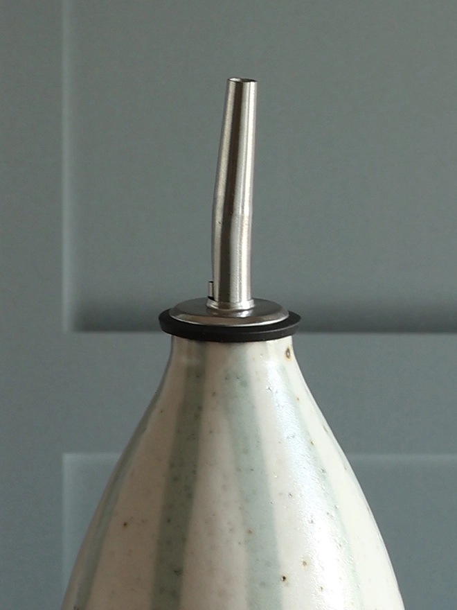 Close-up photograph of our Handmade Ceramic Stoneware Oil Pourer in Blue and White Stripe