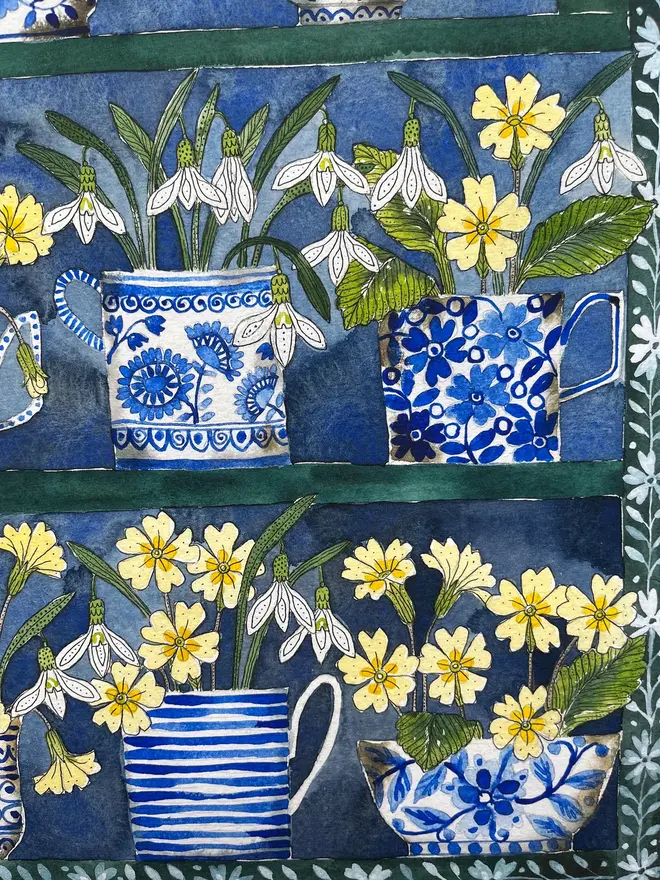 Snowdrops and primroses in delftware, ceramic mugs displayed in a plant Theatre print