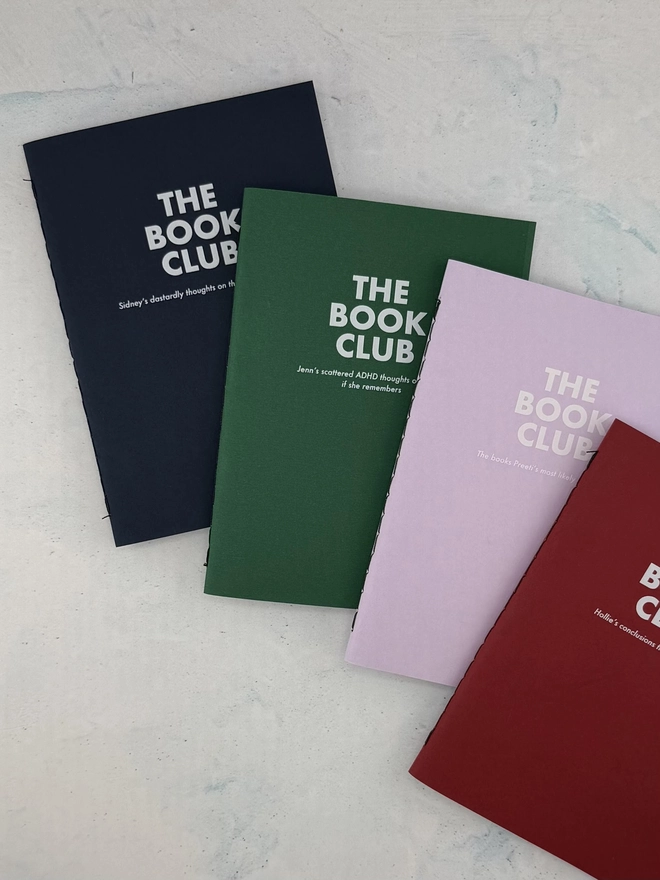 a set of personalised notebooks with the book club written on the front and then personalised with a name