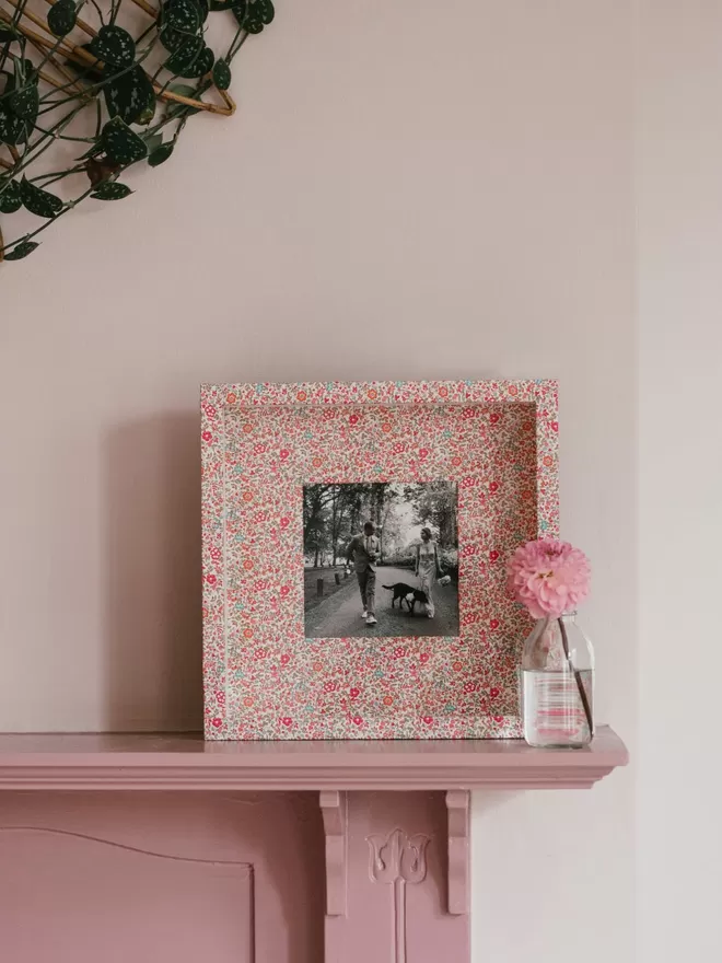 Liberty Fabric Covered Photo Box Frame seen on a pink mantlepiece.