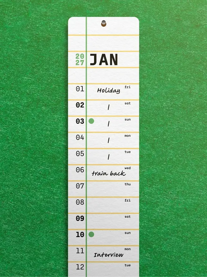 Squared: 2027 Monthly Wall Calendar, on a green wall. 