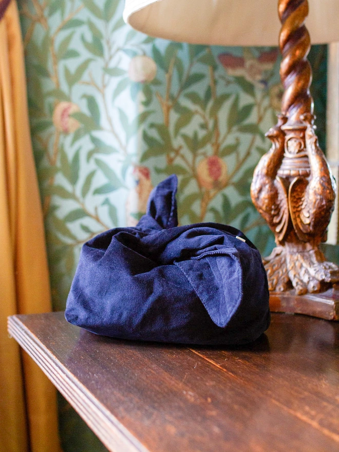 indigo blue bento style bag on wooden table to show ties