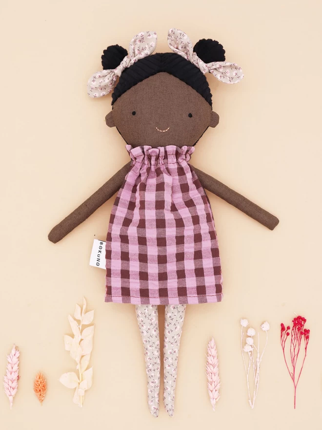 fabric black girl doll with gingham dress and floral bow and tights