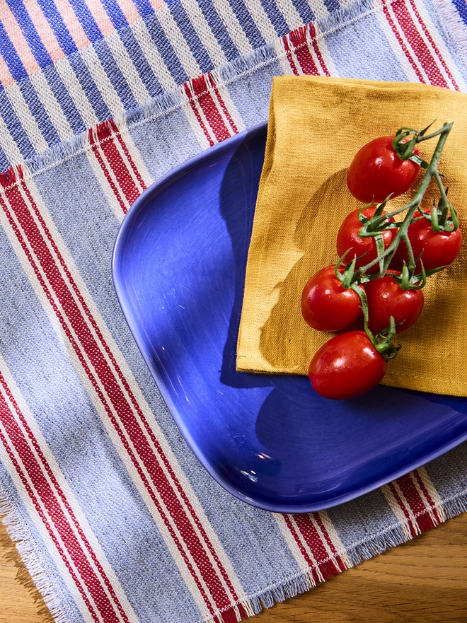 Blue Raspberry Placemat. Sat on Blueberry Pie Runner, paired with blue plate and tomatoes.