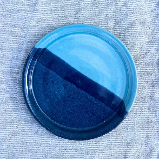 Landscape Side Plate, a colourful plate placed on a stone surface. 