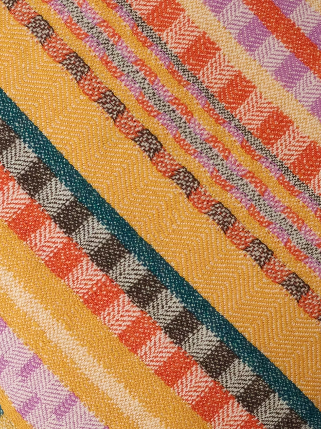 aoife square cushion. a close up of a multi coloured cushion pattern.